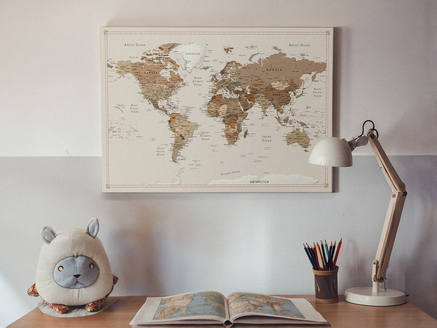 A beautifully framed adventure travel map on a wall, perfect for travellers to pin their journeys. This push pin travel map serves as a stylish and personalised decor piece.