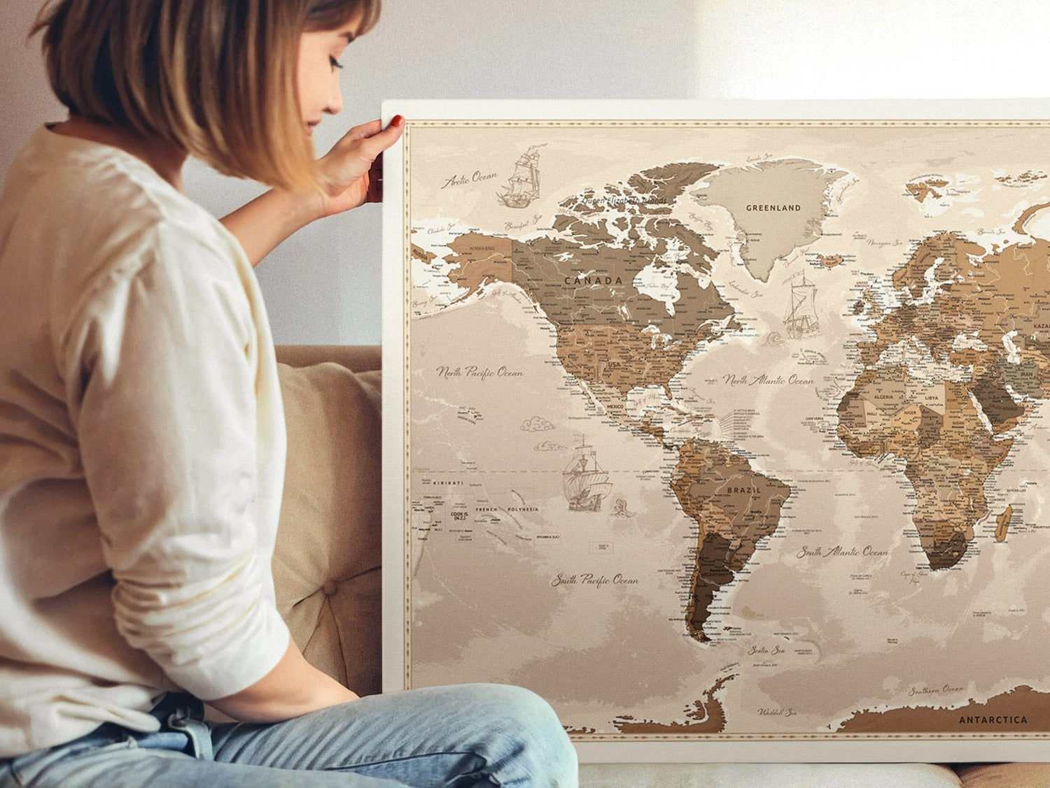 A woman holding a large push pin travel map printing on canvas, designed for tracking adventures. This pinboard map is perfect for marking places you've been and planning future trips.